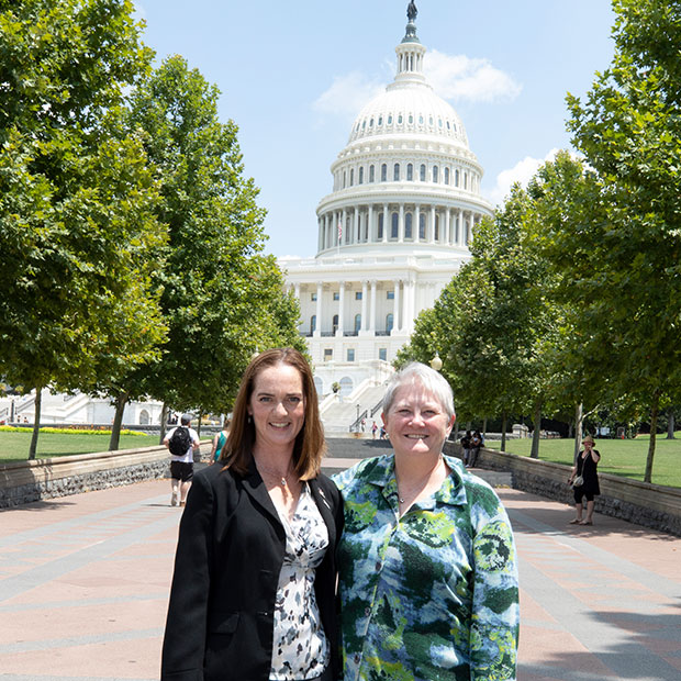 Two women in front of capital building